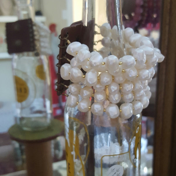 brown leather and brass snap closure with 7 strands of 11mm unique freshwater pearls and gold foil seed crystals bracelet