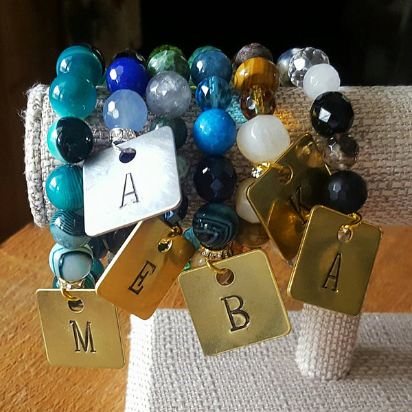 Custom hand stamped brass tags on beaded gemstone bracelets