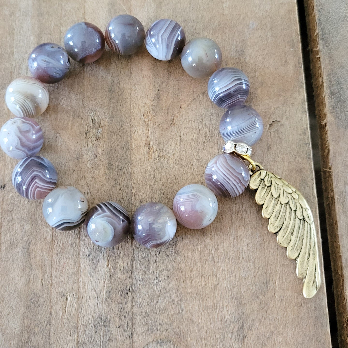 12mm brown swirled agate beads w/ gold wing charm stretch bracelet