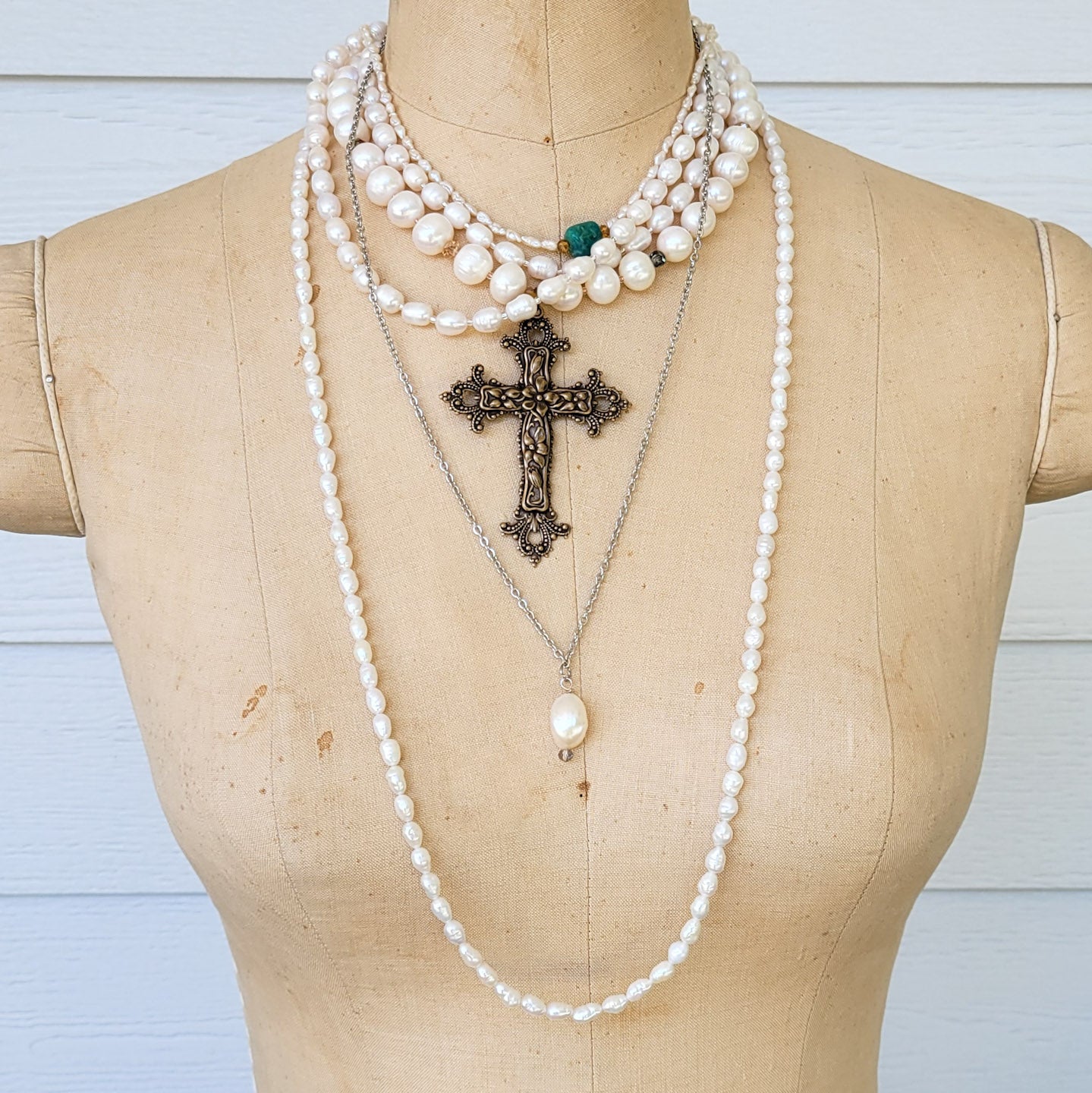 freshwater pearl necklaces layered on mannequin