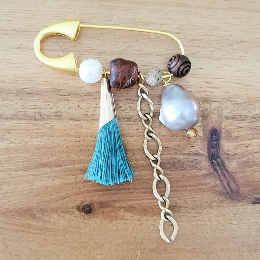 gold safety pin w variety of charms and freshwater pearls