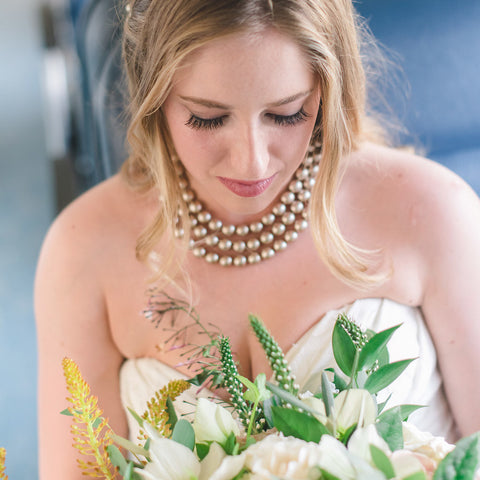 Bride wearing signature triple layer crystal pearl necklace