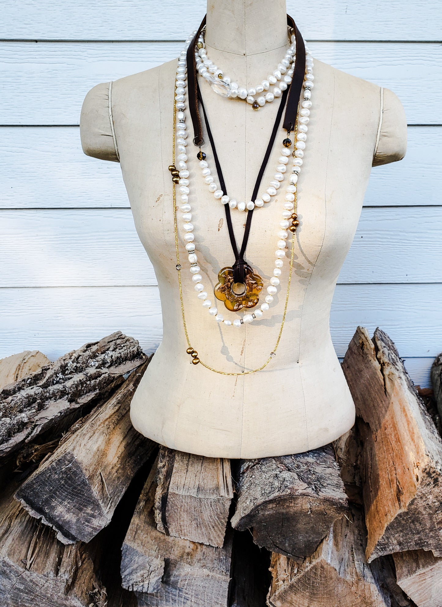 display of many layered handmade necklaces